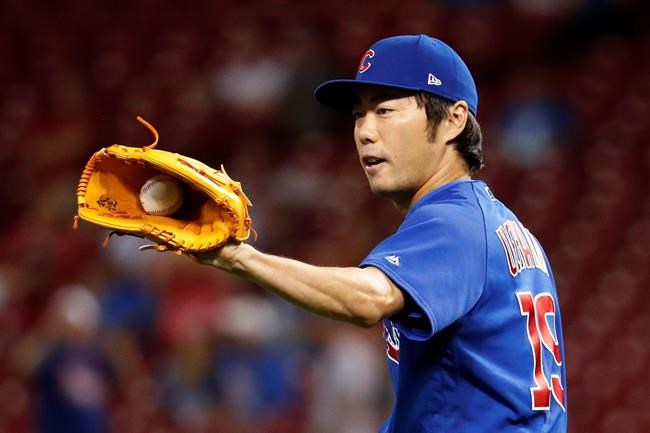 FILE - In this Aug. 23, 2017, file photo, Chicago Cubs relief pitcher Koji Uehara prepares to throw during the eighth inning of the team's baseball game against the Cincinnati Reds in Cincinnati. Uehara, whose dominant season in relief helped the Boston Red Sox win the 2013 World Series, has retired with Japan’s Yomiuri Giants, the team that he first played for in Japan. (AP Photo/John Minchillo, File)