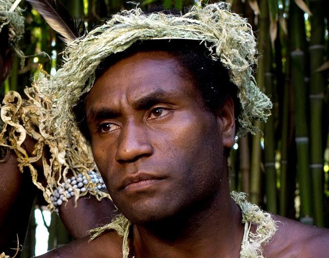 FILE - This Sept. 9, 2015, file photo shows Mungau Dain in Venice, Italy. Dain had never considered acting before he starred in the Oscar-nominated film “Tanna.” He got the role because his elders decided he was the best-looking guy in their traditional village on the Pacific nation of Vanuatu. Dain died Saturday, Jan. 5, 2019, in the capital Port Vila, after contracting a leg infection that wasn’t quickly treated. He was in his mid-20s. (AP Photo/Domenico Stinellis, File)