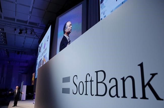 FILE - In this July 20, 2017, file photo, SoftBank Group Corp. Chief Executive Officer Masayoshi Son, left, speaks during a SoftBank World presentation at a hotel in Tokyo. SoftBank Group Corp.’s Japanese mobile subsidiary has gone public in one of the world’s biggest share offerings rivaling that of China’s Alibaba Group. On Wednesday, Dec. 19, 2018, its IPO on the Tokyo Stock Exchange seeks to raise more than 2 trillion yen ($18 billion). (AP Photo/Shizuo Kambayashi, File)