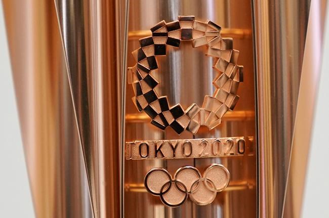 FILE - This March 20, 2019, file photo shows the emblem of the Olympic torch of the Tokyo 2020 Olympic Games during a press conference in Tokyo. Tokyo organizers said Wednesday, May 8, 2019, they are trying to cut spending, under pressure from the International Olympic Committee, which has been widely criticized for driving Olympic cities to build “white elephant” venues, often at the taxpayers expense. (AP Photo/Eugene Hoshiko, File)