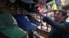In this Thursday, March 21, 2019, image from video, Joey Mellows from Portsmouth, England, checks baseball caps sold at a Major League Baseball shop before Game 2 of the MLB opening series between the Seattle Mariners and the Oakland Athletics held at Tokyo Dome in Tokyo. Mellows, better known by his Twitter feed 