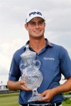 Harris English holds the trophy after winning the St. Jude Classic golf tournament in Memphis, Tenn., with a for his first PGA Tour title, birdieing two of the final three hole and finishing with a 1-under 69 for a 12-under 268 total Sunday, June 9, 2013, in Memphis, Tenn. (AP Photo/Rogelio V. Solis)