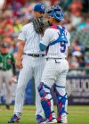 FILE - In this Aug. 19, 2018, file photo, Chicago Cubs' Yu Darvish, left, speaks with South Bend Cubs catcher Miguel Amaya during the Great Lakes Loons at South Bend Cubs baseball game, at Four Winds Field in South Bend, Ind. Catcher Amaya seems to have a bright future with the Chicago Cubs. Cubs director of international pro scouting Alex Suarez says the young prospect has certain intangibles that teams look for behind the plate. Amaya is slowly making his way up, playing last season at Class A South Bend, where he batted .256 with 12 home runs and 52 RBIs in 116 games. (Robert Franklin/South Bend Tribune via AP, File)
