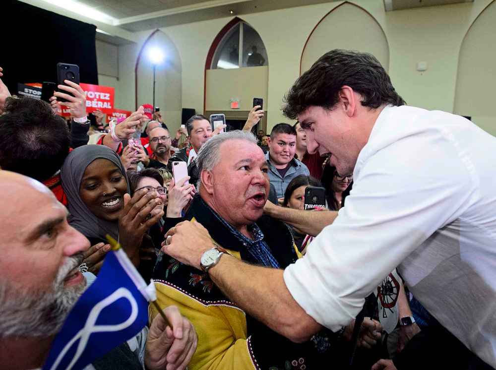 THE CANADIAN PRESS/Sean Kilpatrick
Trudeau embraces David Chartrand, president of the Manitoba Metis Federation at the rally in Winnipeg, Saturday.