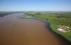 The swollen Assiniboine River covers farmland along Grand Valley Road west of Brandon, Man. as seen from the air on Sunday, July 6, 2014. THE CANADIAN PRESS/Tim Smith