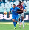 Torino's Soualiho Meite and Fiorentina's Luis Muriel, left, vie for the ball during the second round of the Italian Cup soccer match between Torino and Fiorentina at the Olympic stadium in Turin, Italy, Sunday, Jan. 13, 2019. (Alessandro Di Marco/ANSA via AP)
