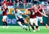 Torino's Cristian Ansaldi, right, challenges Cagliari's Leonardo Pavoletti during the Serie A soccer match between Torino and Cagliari at the Olympic Stadium in Turin, Italy, Sunday, April 14, 2019. (Alessandro Di Marco/ANSA via AP)