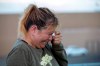 Edie Hallberg cries while speaking to police outside a Walmart store where a shooting occurred earlier in the day as she looks for her missing mother Angie Englisbee, who was in the store during the attack in El Paso, Texas, Saturday, Aug. 3, 2019. Multiple people were killed and one person was in custody after a shooter went on a rampage at a shopping mall, police in the Texas border town of El Paso said. (AP Photo/Andres Leighton)