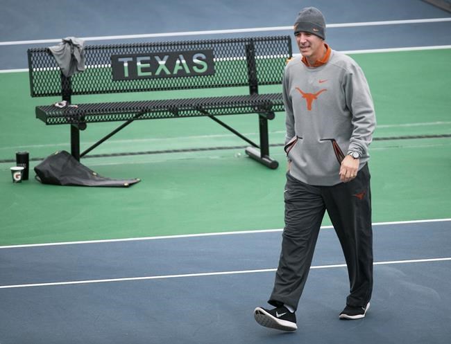 In this January 2018 photo, Texas men’s tennis coach Michael Center surveys the courts before the matches with UTSA, in Austin, Texas. Center is among a few people in the state charged in a scheme that involved wealthy parents bribing college coaches and others to gain admissions for their children at top schools, federal prosecutors said Tuesday, March 12, 2019. (Ralph Barrera/Austin American-Statesman via AP)
