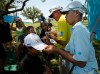 In this photo taken Tuesday, May 14, 2013, Guan Tianlang, 14, from China, and signs autographs with Matt Bettencourt sign autographs on the 17th hole during a practice round at Byron Nelson Championship golf tournament in Irving, Texas. (AP Photo/The Dallas Morning News, Brad Loper) MANDATORY CREDIT; MAGS OUT; TV OUT; INTERNET USE AP MEMBERS ONLY; NO SALES.