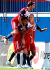 FC Dallas midfielder Ryan Hollingshead (12) jumps onto teammates surrounding orward Zdenek Ondrasek (13) after Ondrasek scored the first goal of an MLS soccer match during the first half against Sporting Kansas City in Frisco, Texas, Sunday, Oct. 6, 2019. (Stewart F. House/The Dallas Morning News via AP)