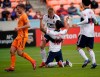 Vancouver Whitecaps's Fredy Montero (12) celebrates with Andy Rose, rear, after scoring on a penalty kick as Houston Dynamo's Adam Lundqvist (3) runs past during the first half of an MLS soccer match Saturday, March 16, 2019, in Houston. (AP Photo/David J. Phillip)