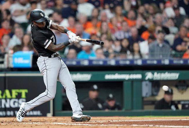 Chicago White Sox's Tim Anderson hits an RBI single against the Houston Astros during the third inning of a baseball game Thursday, May 23, 2019, in Houston. (AP Photo/David J. Phillip)