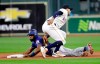 Texas Rangers' Elvis Andrus, bottom, is tagged out by Houston Astros shortstop Carlos Correa while trying to steal second base during the first inning of a baseball game Tuesday, Sept. 17, 2019, in Houston. (AP Photo/David J. Phillip)