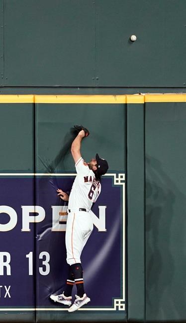 Houston Astros center fielder Jake Marisnick leaps at the wall while trying to catch a home run by Chicago White Sox's Eloy Jimenez during the second inning of a baseball game Wednesday, May 22, 2019, in Houston. (AP Photo/David J. Phillip)