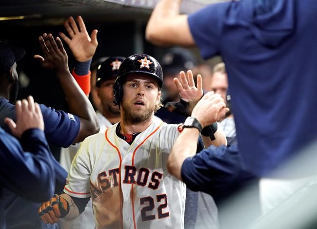 Houston Astros' Josh Reddick (22) celebrates with teammates in the dugout after scoring against the Seattle Mariners during the second inning of a baseball game Saturday, June 29, 2019, in Houston. (AP Photo/David J. Phillip)