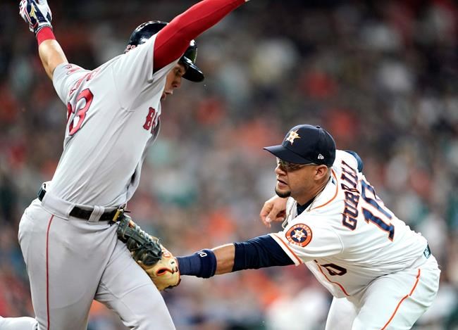 Boston Red Sox's Michael Chavis, left, is tagged out by Houston Astros first baseman Yuli Gurriel (10) during the fourth inning of a baseball game Saturday, May 25, 2019, in Houston. (AP Photo/David J. Phillip)