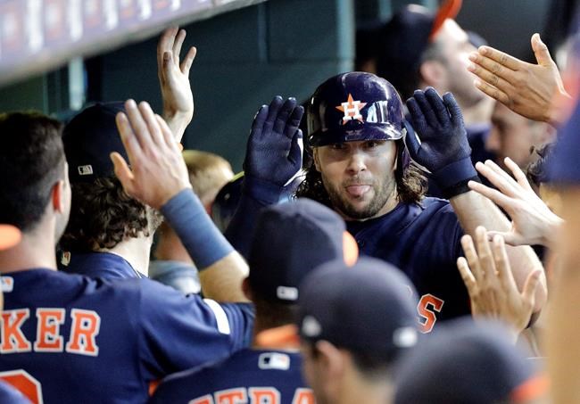 Houston Astros' Jake Marisnick is congratulated in the dugout after hitting a two-run home run against the Seattle Mariners during the second inning of a baseball game Sunday, Sept. 8, 2019, in Houston. (AP Photo/David J. Phillip)
