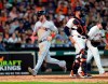 Cleveland Indians' Tyler Naquin, left, scores as Houston Astros catcher Max Stassi stands in front of home plate during the seventh inning of a baseball game Saturday, April 27, 2019, in Houston. (AP Photo/David J. Phillip)
