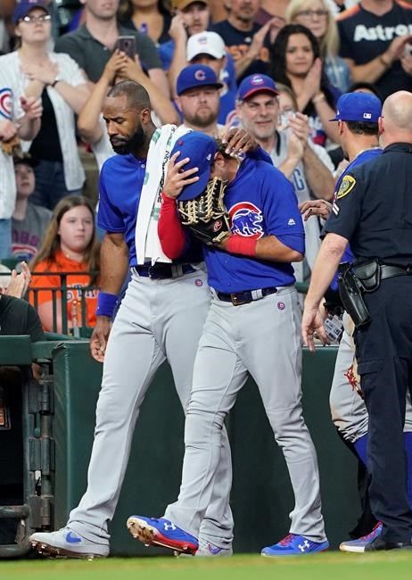 Chicago Cubs' Albert Almora Jr., right, is comforted by Jason Heyward after checking on an injured fan from his foul ball during the fourth inning of a baseball game against the Houston Astros Wednesday, May 29, 2019, in Houston. (AP Photo/David J. Phillip)