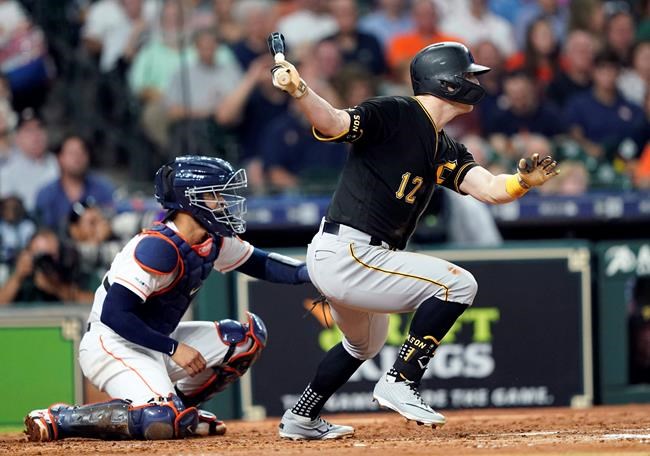 Pittsburgh Pirates' Corey Dickerson (12) hits a two-run single as Houston Astros catcher Robinson Chirinos watches during the third inning of a baseball game Wednesday, June 26, 2019, in Houston. (AP Photo/David J. Phillip)