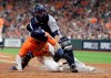 Houston Astros' Alex Bregman, bottom, scores as Seattle Mariners catcher Austin Nola loses the ball during the fifth inning of a baseball game Friday, Sept. 6, 2019, in Houston. (AP Photo/David J. Phillip)