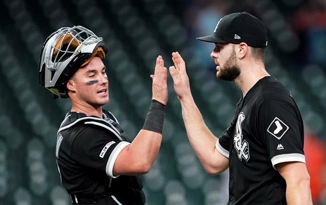 Chicago White Sox catcher James McCann, left, celebrates with starting pitcher Lucas Giolito after the team's baseball game against the Houston Astros Thursday, May 23, 2019, in Houston. Giolito threw a four-hitter as the White Sox won 4-0. (AP Photo/David J. Phillip)