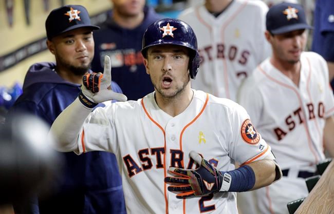 Houston Astros' Alex Bregman celebrates in the dugout after hitting a home run against the Seattle Mariners during the sixth inning of a baseball game Saturday, Sept. 7, 2019, in Houston. (AP Photo/David J. Phillip)