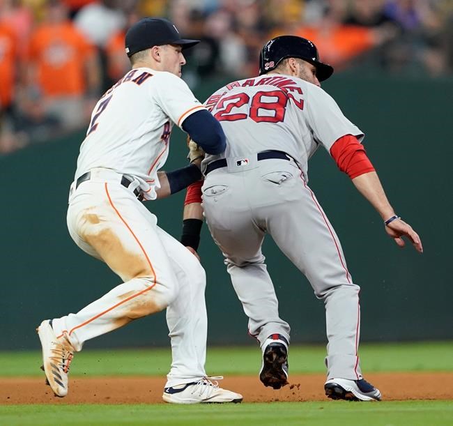 Boston Red Sox's J.D. Martinez (28) is tagged out by Houston Astros third baseman Alex Bregman (2) after being caught in a rundown during the seventh inning of a baseball game Saturday, May 25, 2019, in Houston. (AP Photo/David J. Phillip)