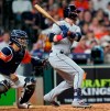 Cleveland Indians' Tyler Naquin, right, hits an RBI double to score Greg Allen as Houston Astros catcher Robinson Chirinos watches during the seventh inning of a baseball game Friday, April 26, 2019, in Houston. (AP Photo/David J. Phillip)