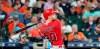 Los Angeles Angels' Jonathan Lucroy hits an RBI triple against the Houston Astros during the fifth inning of a baseball game Sunday, July 7, 2019, in Houston. (AP Photo/David J. Phillip)
