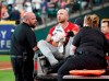 Los Angeles Angels' Jonathan Lucroy, center, is carted off the field after colliding with Houston Astros' Jake Marisnick at home plate during the eighth inning of a baseball game Sunday, July 7, 2019, in Houston. (AP Photo/David J. Phillip)