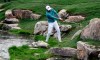 Jordan Spieth hits from the bank of a creek on the 18th hole during the final round of the Texas Open golf tournament Sunday, April 7, 2019, in San Antonio. (AP Photo/Eric Gay)