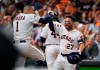 Houston Astros second baseman Jose Altuve (27) celebrates his solo home run against the Tampa Bay Rays with Carlos Correa (1) during the eighth inning of Game 5 of a baseball American League Division Series in Houston, Thursday, Oct. 10, 2019. (AP Photo/Eric Christian Smith)