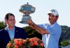 Kevin Kisner, right, holds his trophy presented by Michael Dell, CEO of Dell Technologies, after he defeated Matt Kuchar in the finals at the Dell Technologies Match Play Championship golf tournament, Sunday, March 31, 2019, in Austin, Texas. (AP Photo/Eric Gay)