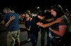 Members of Iglesia Cristiana Manatial en el Desierto pray with El Pasoans who came to hold vigil Monday, Aug. 5, 2019, outside the Walmart in El Paso, Texas, where a mass shooting took place on Saturday. (Mark Lambie/The El Paso Times via AP)