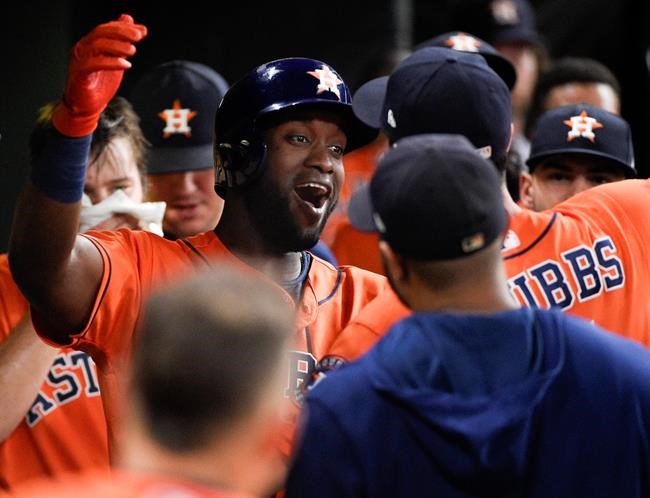 Houston Astros designated hitter Yordan Alvarez, left, celebrates his solo home run off Seattle Mariners starting pitcher Yusei Kikuchi with Garrett Stubbs during the second inning of a baseball game Friday, Aug. 2, 2019, in Houston. (AP Photo/Eric Christian Smith)