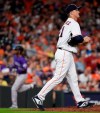 Houston Astros starting pitcher Zack Greinke, right, walks back to the mound as Colorado Rockies' Raimel Tapia, back left, rounds the bases after hitting a three-run home run during the sixth inning of a baseball game Tuesday, Aug. 6, 2019, in Houston. (AP Photo/Eric Christian Smith)