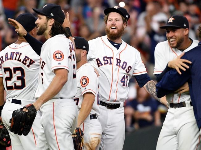 Houston Astros relief pitcher Chris Devenski, second from right, and teammates celebrate the team's 9-0 win over the Seattle Mariners, with a four-pitcher combined no-hitter, in a baseball game Saturday, Aug. 3, 2019, in Houston. (AP Photo/Eric Christian Smith)