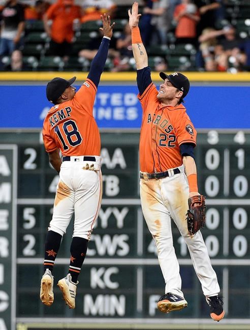 Houston Astros' Tony Kemp (18) and Josh Reddick celebrate their win over the Toronto Blue Jays in a baseball game, Friday, June 14, 2019, in Houston. (AP Photo/Eric Christian Smith)