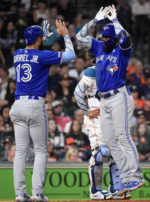 Toronto Blue Jays' Teoscar Hernandez, right, celebrates his three-run home run off Houston Astros relief pitcher Cionel Perez with Lourdes Gurriel Jr. during the sixth inning of a baseball game, Sunday, June 16, 2019, in Houston. (AP Photo/Eric Christian Smith)