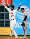 Houston Astros' Robinson Chirinos, left, reacts after his game-tying two-run double as New York Yankees shortstop Gleyber Torres looks on during the seventh inning of a baseball game Monday, April 8, 2019, in Houston. (AP Photo/Eric Christian Smith)
