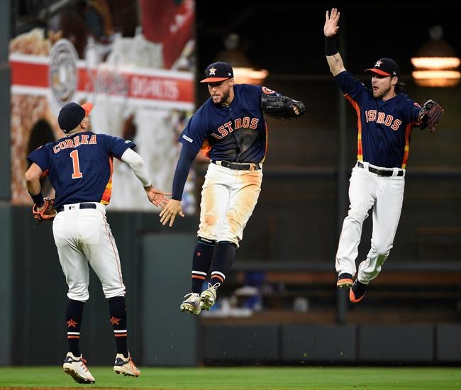 Houston Astros' Carlos Correa (1), George Springer, center, and Josh Reddick celebrates the team's 11-4 win over the Texas Rangers in a baseball game, Saturday, May 11, 2019, in Houston. (AP Photo/Eric Christian Smith)