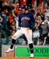 Houston Astros' George Springer reacts after scoring the tying run on Alex Bregman's sacrifice during the eighth inning of the team's baseball game against the Oakland Athletics, Sunday, April 7, 2019, in Houston. (AP Photo/Eric Christian Smith)