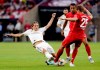 Real Madrid forward Gareth Bale, left, slides as he goes for the ball against FC Bayern's Thiago Alcântara, center, and Thomas Muller (25) during the first half of an International Champions Cup soccer match Saturday, July 20, 2019, in Houston. (AP Photo/Michael Wyke)