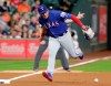 Texas Rangers third baseman Asdrubal Cabrera (14) loses the ball on the infield grounder by Houston Astros George Springer during the first inning of a baseball game Thursday, May 9, 2019, in Houston. (AP Photo/Michael Wyke)