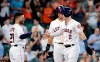 Houston Astros Jose Altuve (27) Michael Brantley, middle, and Alex Bregman (2) celebrate after they all scored on the RBI double hit by Yuli Gurriel during the fourth inning of a baseball game against the Colorado Rockies Wednesday, August 7, 2019, in Houston. (AP Photo/Michael Wyke)