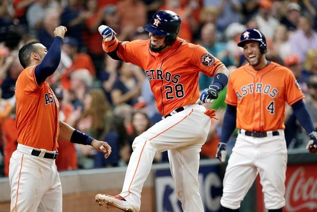 Houston Astros Carlos Correa, left, Robinson Chirinos, middle, and George Springer (4) celebrate a home run by Chirinos during the seventh inning of the team's baseball game against the Texas Rangers on Friday, May 10, 2019, in Houston. (AP Photo/Michael Wyke)