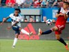 Vancouver Whitecaps forward Yordi Reyna, left, takes a shot as FC Dallas defender Matt Hedges (24) attempts to block during the first half of an MLS soccer match in Frisco, Texas, Wednesday, June 26, 2019. (AP Photo/Tony Gutierrez)