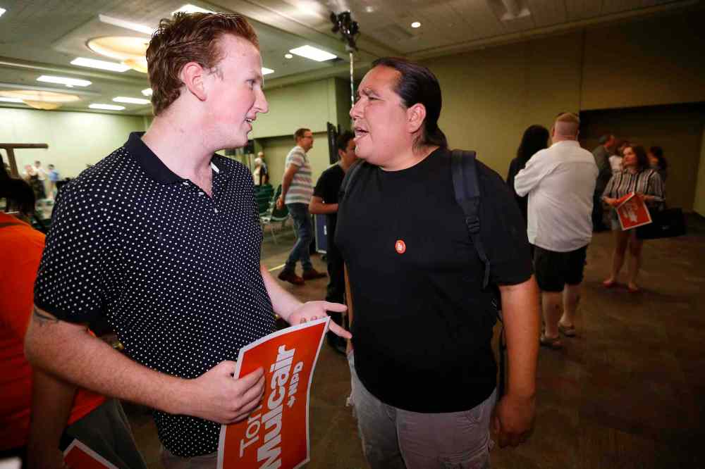 CP
A NDP supporter talks with Protester Clayton Thomas-Muller, right, as NDP leader Tom Mulcair makes a campaign stop in Winnipeg to meet and talk with supporters. A speech Mulcair to close to 1,000 NDP supporters in Winnipeg was interrupted by protesters Thursday night. (John Woods / The Canadian Press)